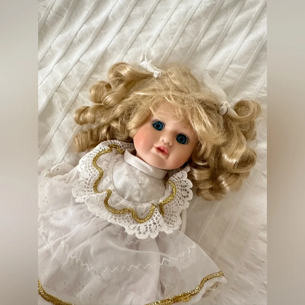 Victorian style porcelain doll with curly blond hair